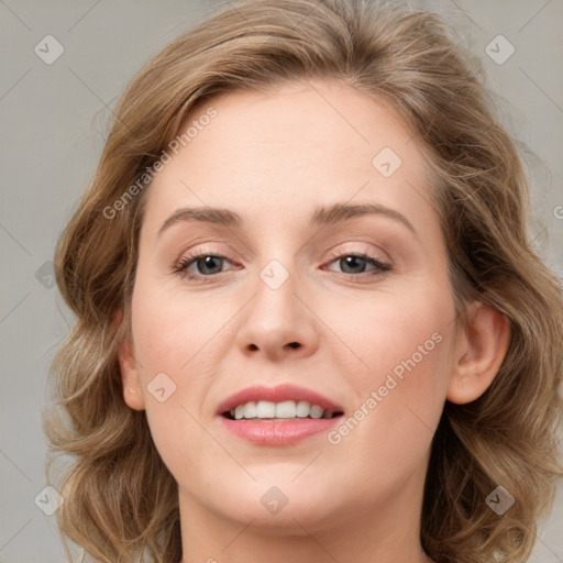 Joyful white young-adult female with medium  brown hair and blue eyes