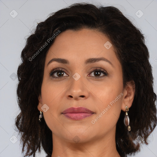 Joyful latino adult female with medium  brown hair and brown eyes