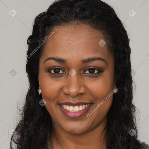 Joyful black young-adult female with long  brown hair and brown eyes