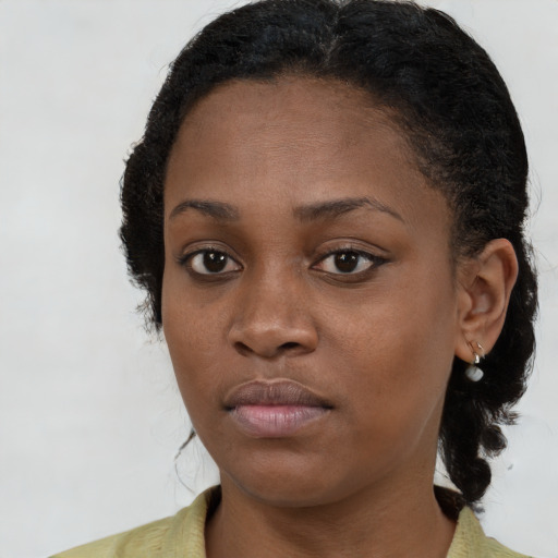 Neutral black young-adult female with long  brown hair and brown eyes