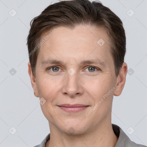 Joyful white adult male with short  brown hair and grey eyes