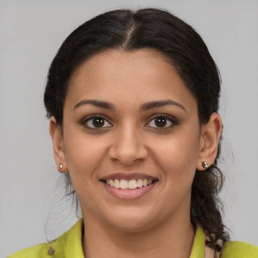 Joyful latino young-adult female with medium  brown hair and brown eyes