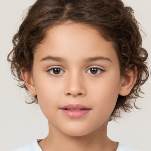 Joyful white child female with medium  brown hair and brown eyes