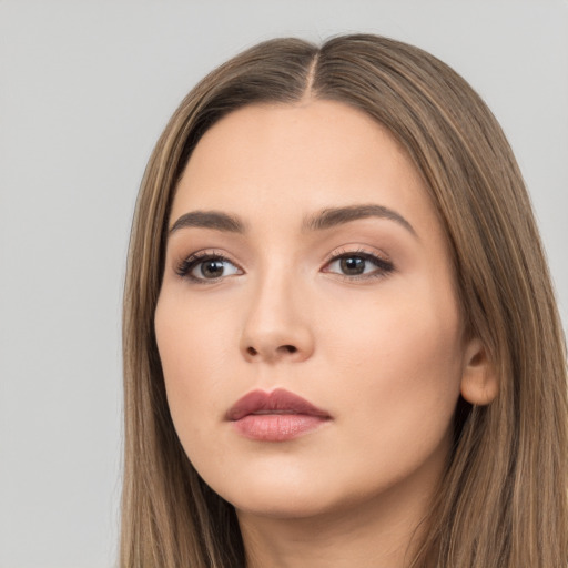 Neutral white young-adult female with long  brown hair and brown eyes