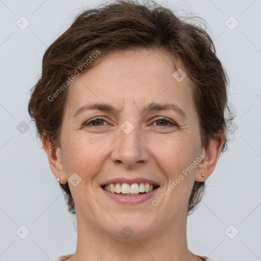 Joyful white adult female with short  brown hair and brown eyes