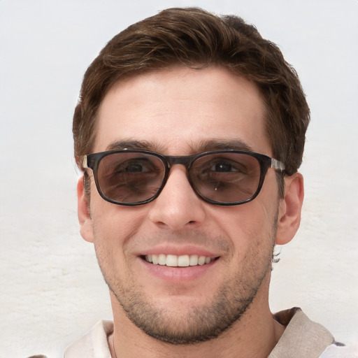 Joyful white young-adult male with short  brown hair and blue eyes