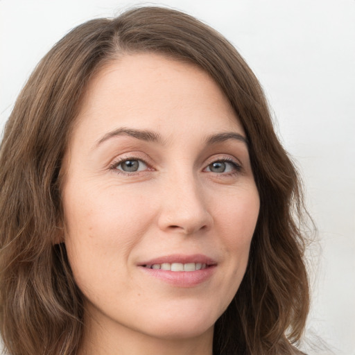 Joyful white young-adult female with long  brown hair and green eyes