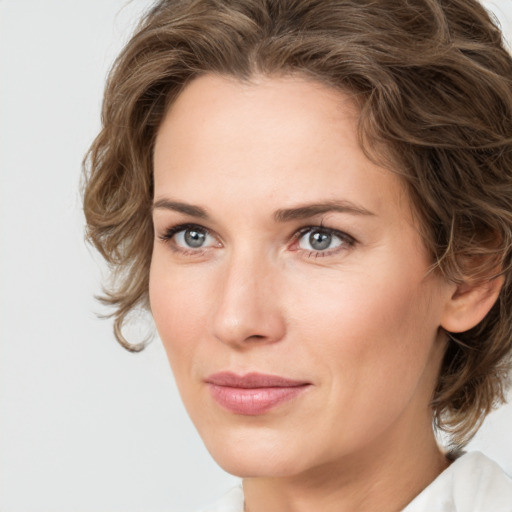 Joyful white young-adult female with medium  brown hair and green eyes