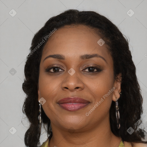 Joyful black young-adult female with long  brown hair and brown eyes