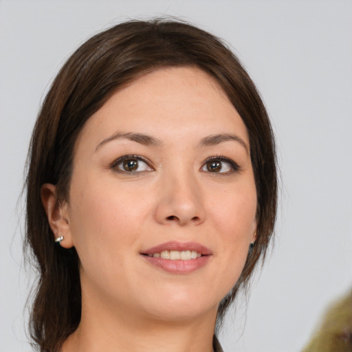 Joyful white young-adult female with medium  brown hair and brown eyes