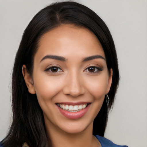 Joyful latino young-adult female with long  black hair and brown eyes