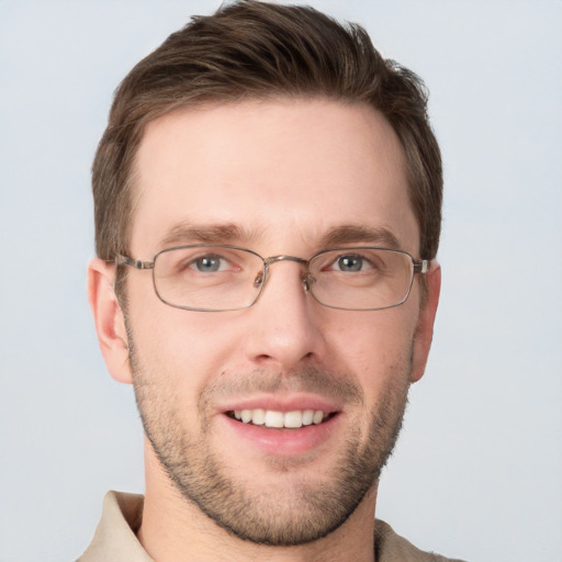 Joyful white young-adult male with short  brown hair and grey eyes