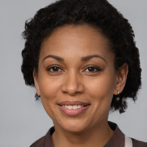 Joyful latino adult female with short  brown hair and brown eyes