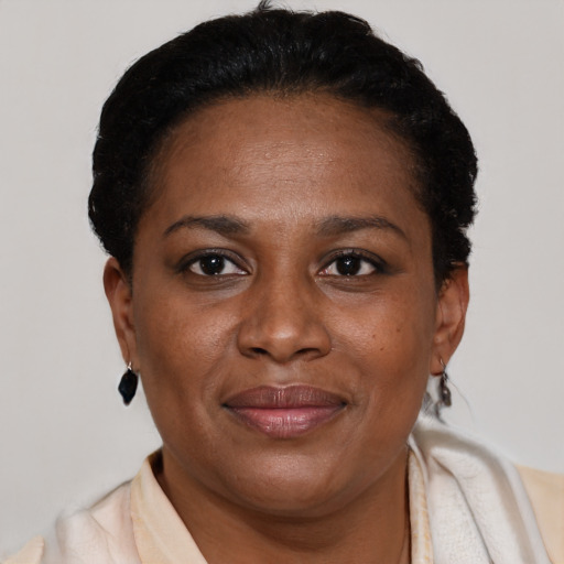 Joyful black adult female with short  brown hair and brown eyes
