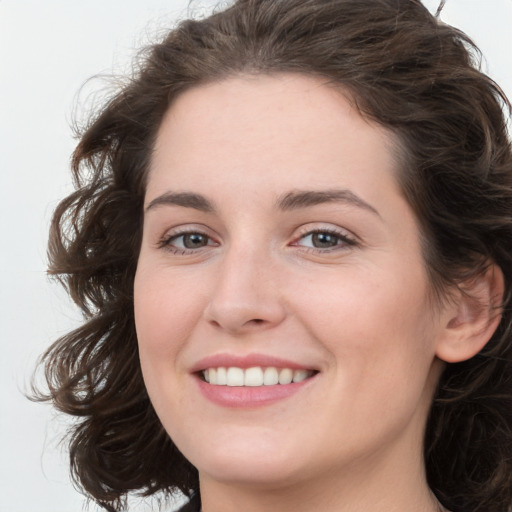 Joyful white young-adult female with medium  brown hair and green eyes