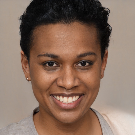 Joyful black young-adult female with short  brown hair and brown eyes