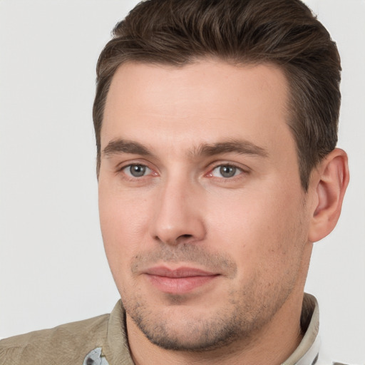 Joyful white young-adult male with short  brown hair and brown eyes