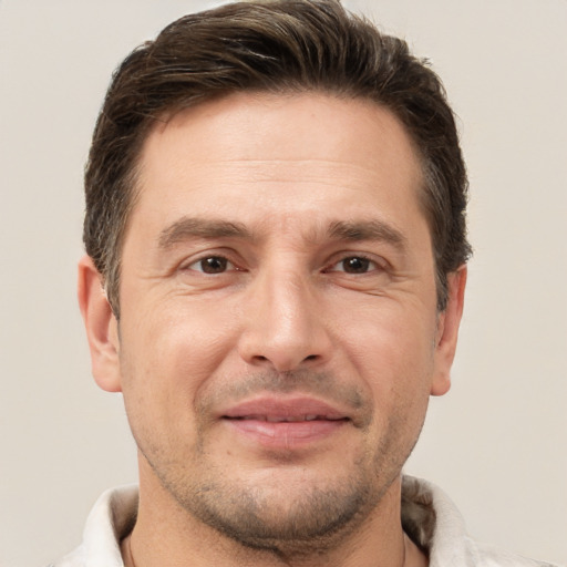 Joyful white adult male with short  brown hair and brown eyes