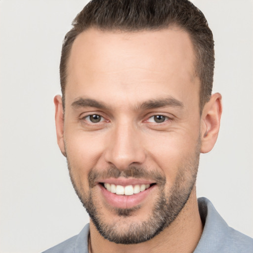 Joyful white young-adult male with short  brown hair and brown eyes