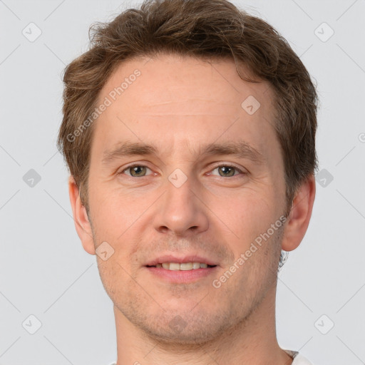 Joyful white adult male with short  brown hair and grey eyes