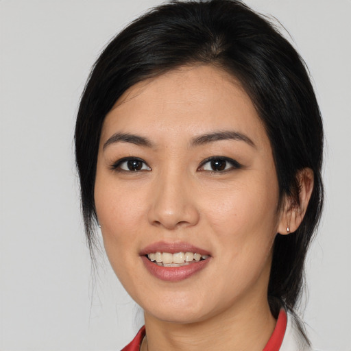 Joyful asian young-adult female with medium  black hair and brown eyes