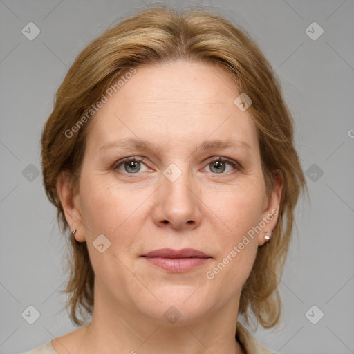 Joyful white adult female with medium  brown hair and grey eyes