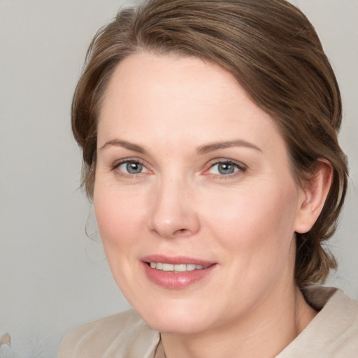 Joyful white young-adult female with medium  brown hair and blue eyes