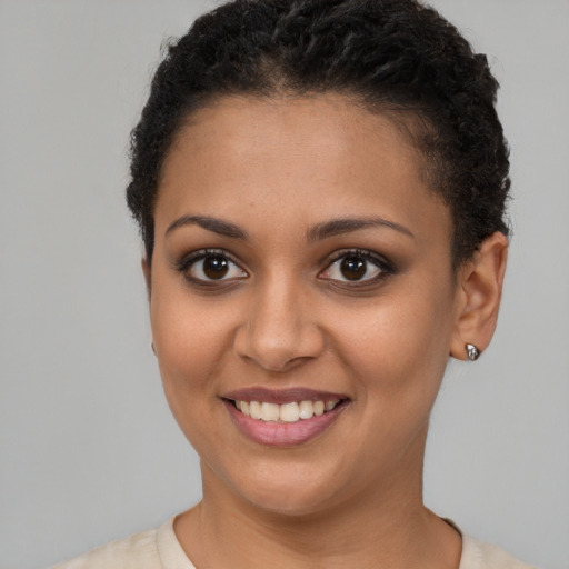 Joyful latino young-adult female with short  brown hair and brown eyes