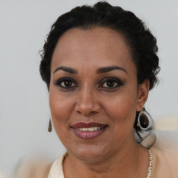 Joyful black adult female with short  brown hair and brown eyes