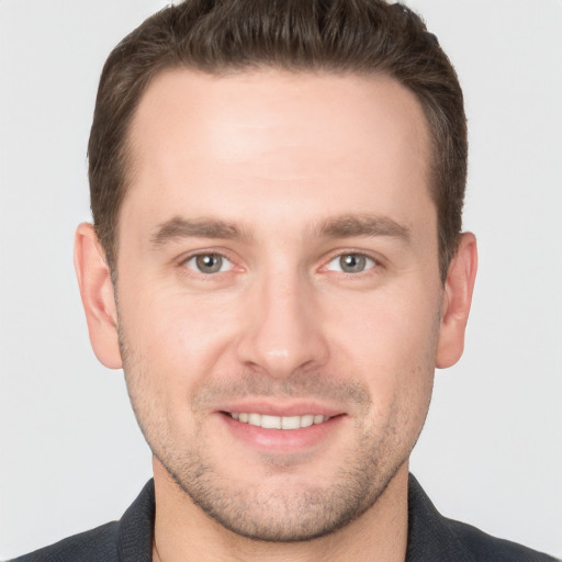 Joyful white young-adult male with short  brown hair and brown eyes