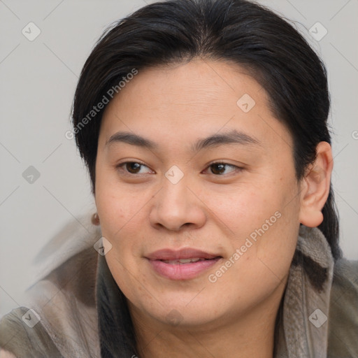 Joyful asian adult female with medium  brown hair and brown eyes