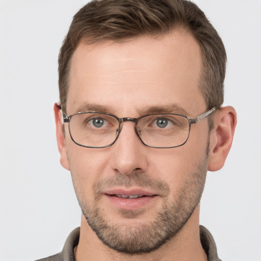 Joyful white adult male with short  brown hair and grey eyes