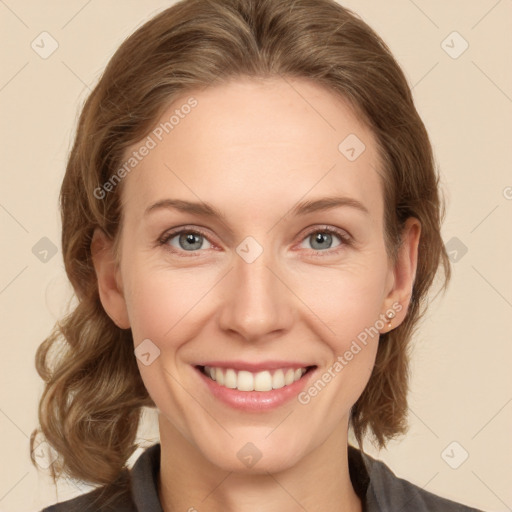 Joyful white adult female with medium  brown hair and grey eyes