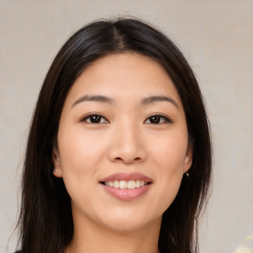 Joyful asian young-adult female with long  brown hair and brown eyes