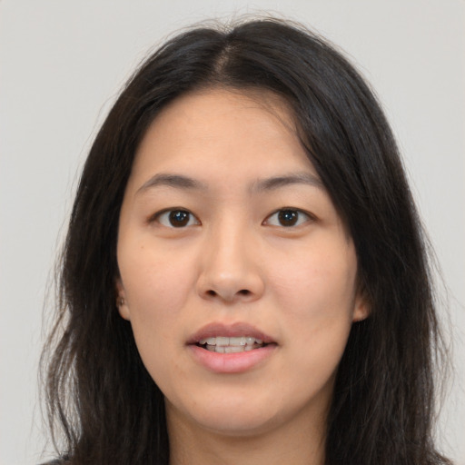 Joyful white young-adult female with long  brown hair and brown eyes