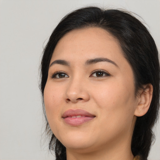 Joyful asian young-adult female with long  brown hair and brown eyes