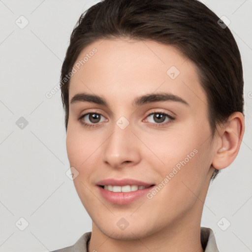 Joyful white young-adult female with short  brown hair and brown eyes