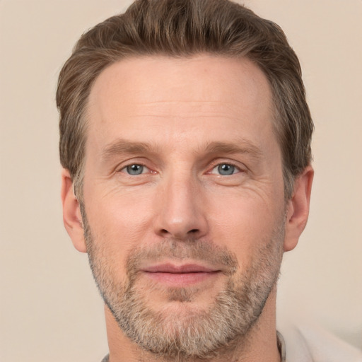 Joyful white adult male with short  brown hair and grey eyes