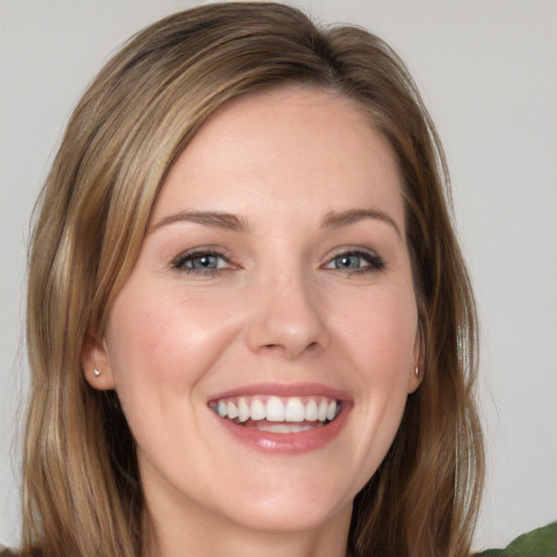 Joyful white young-adult female with long  brown hair and grey eyes