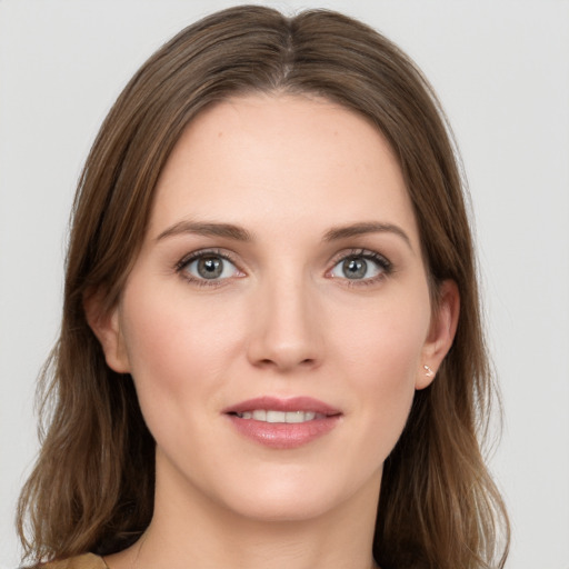 Joyful white young-adult female with long  brown hair and grey eyes