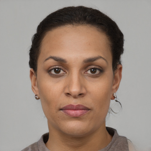 Joyful latino young-adult female with short  brown hair and brown eyes