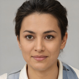 Joyful latino young-adult female with short  brown hair and brown eyes