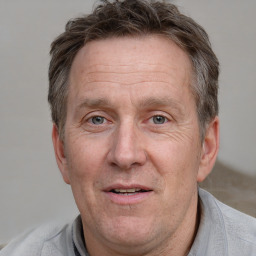 Joyful white middle-aged male with short  brown hair and grey eyes