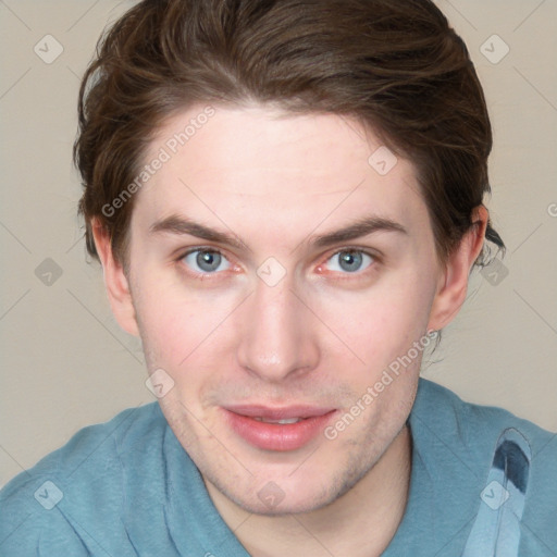 Joyful white young-adult male with short  brown hair and blue eyes