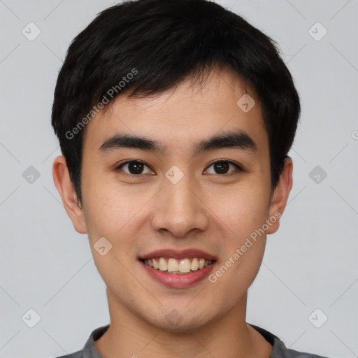 Joyful asian young-adult male with short  black hair and brown eyes