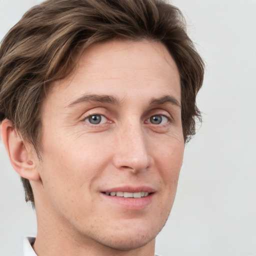 Joyful white adult male with short  brown hair and grey eyes