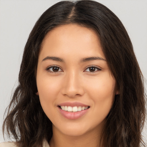 Joyful white young-adult female with long  brown hair and brown eyes