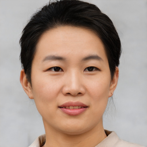 Joyful asian young-adult female with short  brown hair and brown eyes