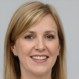 Joyful white adult female with long  brown hair and grey eyes