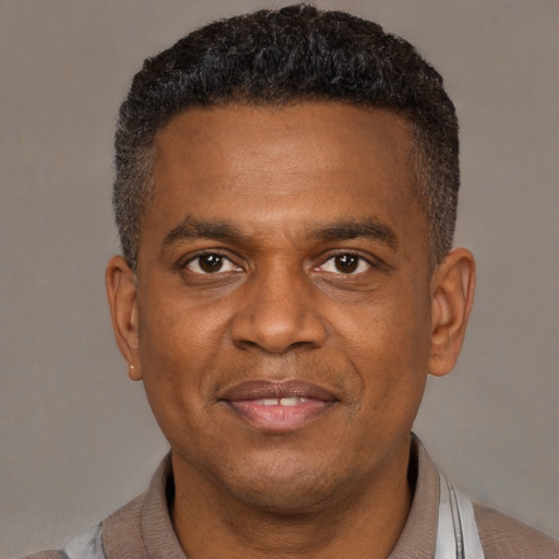 Joyful latino adult male with short  brown hair and brown eyes